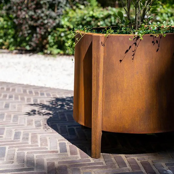 Jardinera redondo de acero Corten con patas, 100 x 60 cm.