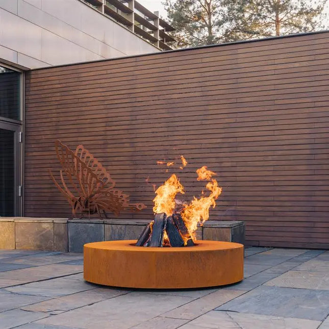 Mesa redonda de acero Corten con parrilla, 125 x 28 cm.